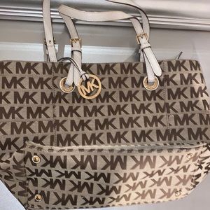 MK handbag. Tan. Has several pockets. Medium size. Comes with purse straps.